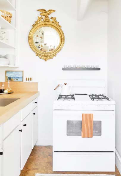 White and Gold Kitchen With Butcher Block Countertops